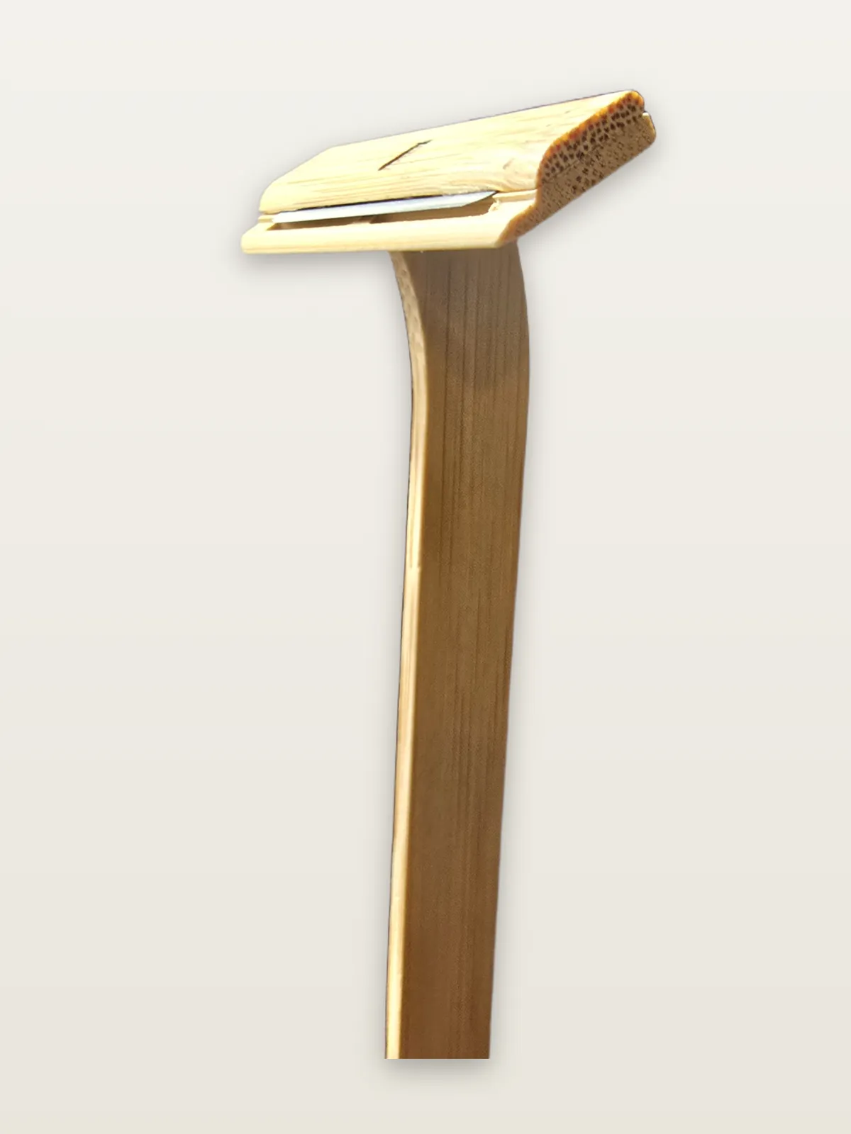 Close-up of the Nomad razor's pressed bamboo handle and stainless-steel blade